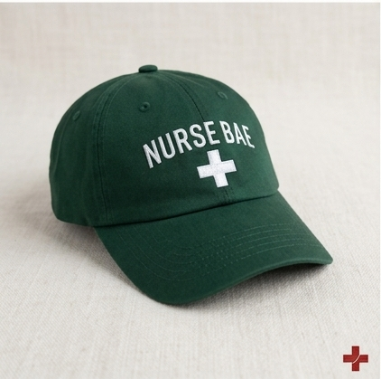 Green Nurse Bae embroidered dad hat on woman, scrub-inspired nurse cap with adjustable strap for comfort”